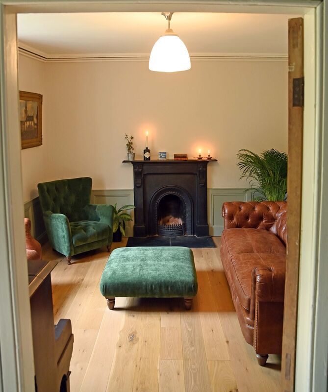 Thanks to wainscotting, the front room retains a period feel with modern Farrow &amp; Ball Elephant’s Breath and Pigeon wall colours.