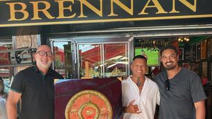 <p>AN IRISHMAN ABROAD: Trevor Brennan outside Brennan’s Bar in Castelginest with the Bouclier de Brennus and Hika Elliot, the former Chief’s hooker, and former All Blacks legend and former Toulouse player Jerome Kaino (right). ‘After games, I’d have a reception and stuff and they’d flock out to the bars. They know they don’t get hassle,’ says Brennan. Pic: Facebook</p>