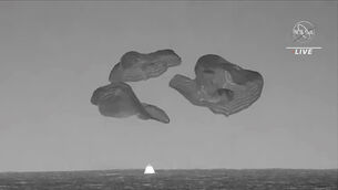 In this image from video made available by NASA, a SpaceX capsule, slowed by parachutes, splashes down in the Atlantic Ocean off the Florida coast, Monday, Sept. 4, 2023, as it returns to Earth with NASA astronaut Stephen Bowen, United Arab Emirates astronaut Sultan al-Neyadi, NASA astronaut Warren (Woody) Hoburg and Roscosmos cosmonaut Andrei Fedyaev after a six-month stay at the International Space Station. (NASA via AP)