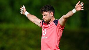 <p>READY TO GO: Hugo Keenan stretches before an Ireland rugby squad training session at Complexe de la Chambrerie in Tours, France. Pic: Brendan Moran/Sportsfile</p>