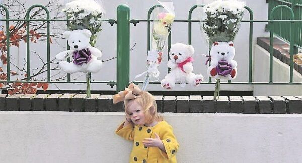A child after placing flowers and teddy bears at the scene of the fire on Kilcronan Ave, Clondalkin. Picture: Colin Keegan