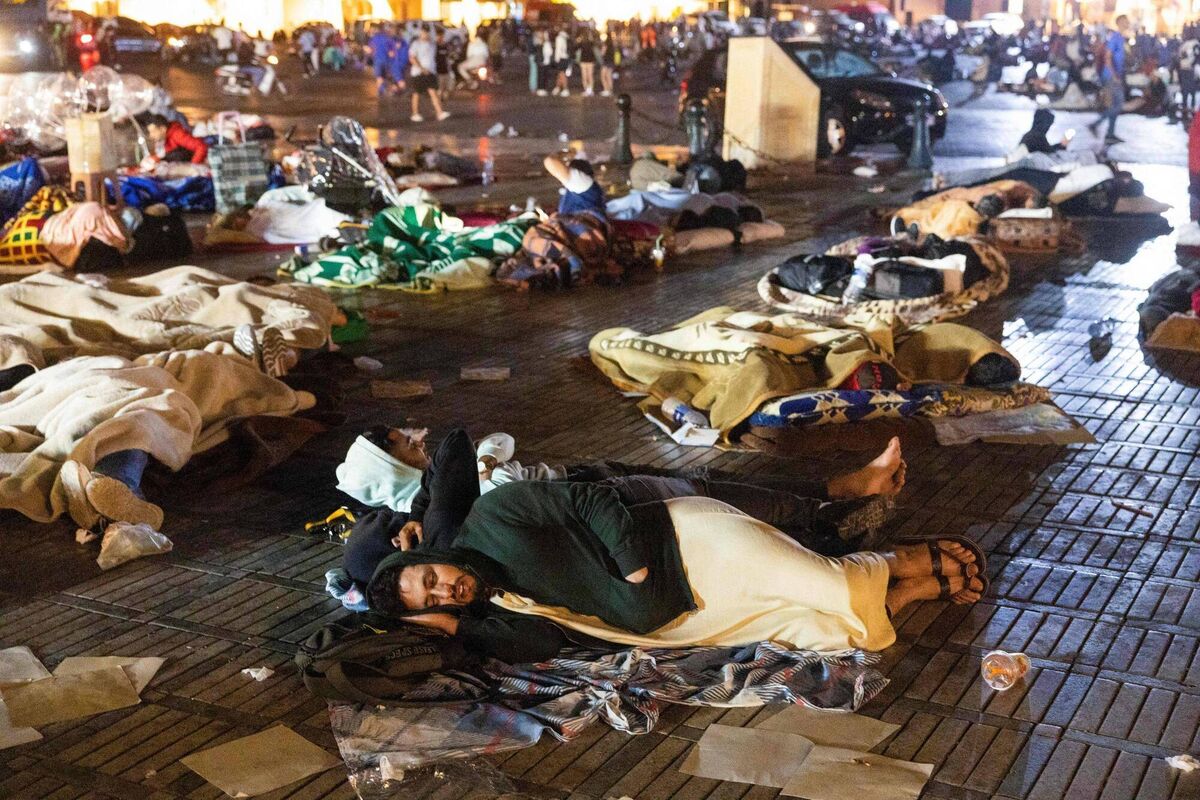 Residents take shelter ouside at a square following an earthquake in Marrakesh on September 9, 2023. 