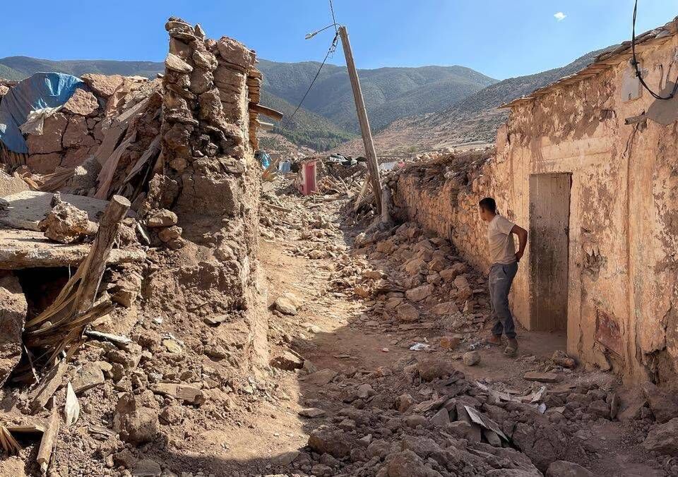 A person stands near damaged houses in Tafeghaghte, a remote village of the High Atlas mountains. Picture: Reuters