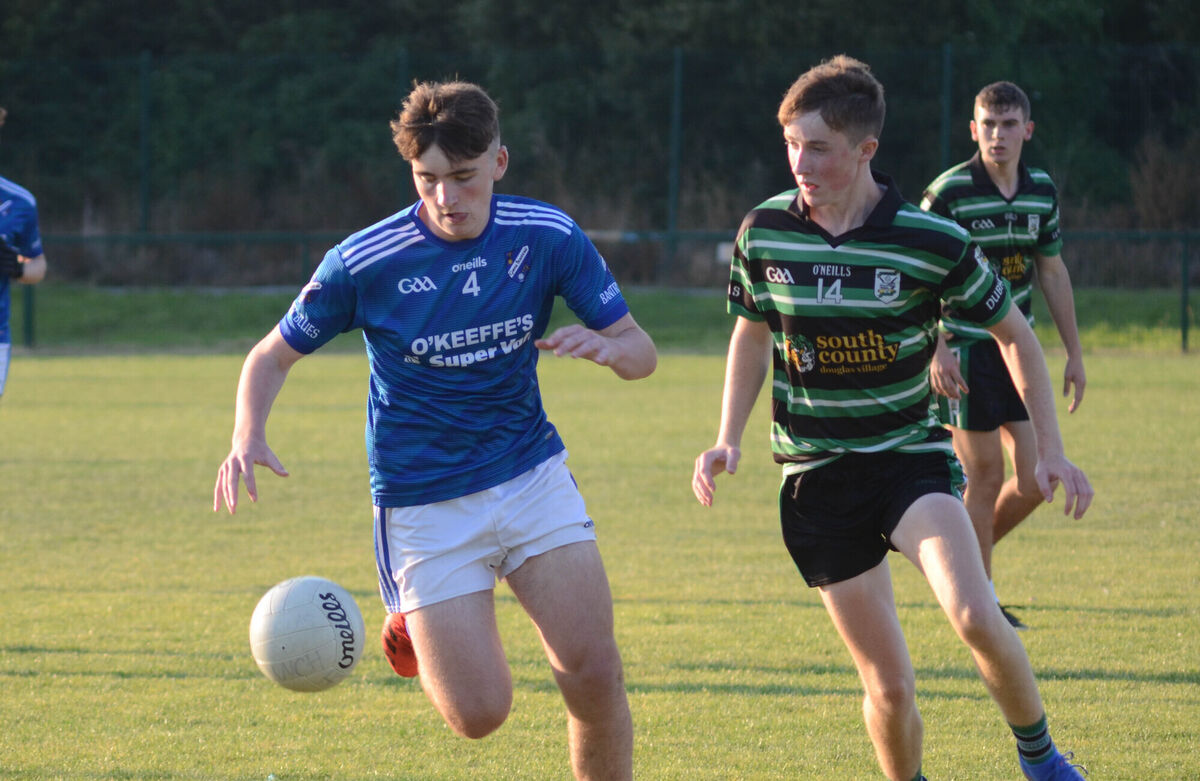 UNDERAGE GRADUATE: Banty Blues Eoin Bowden keeps the ball away from Rob Hanley of Douglas during their 2022 Rebel Og P1 Minor football meeting. Pic: Howard Crowdy