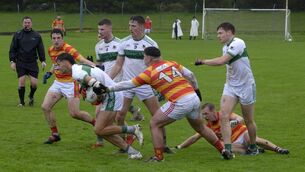 <p>BREAKING THROUGH: Newcestown's Edmund Kennelly tackling Kanturk's Alan Walsh. Pic: Denis Boyle</p>