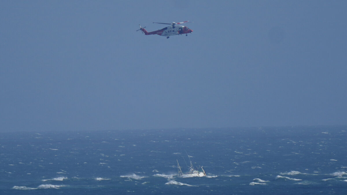 A helicopter from the Irish Coast Guard hovers above a stranded boat off the coast of Blackwater, Wexford. A major multi-agency operation is underway off the coast of Wexford after a boat ran aground. 