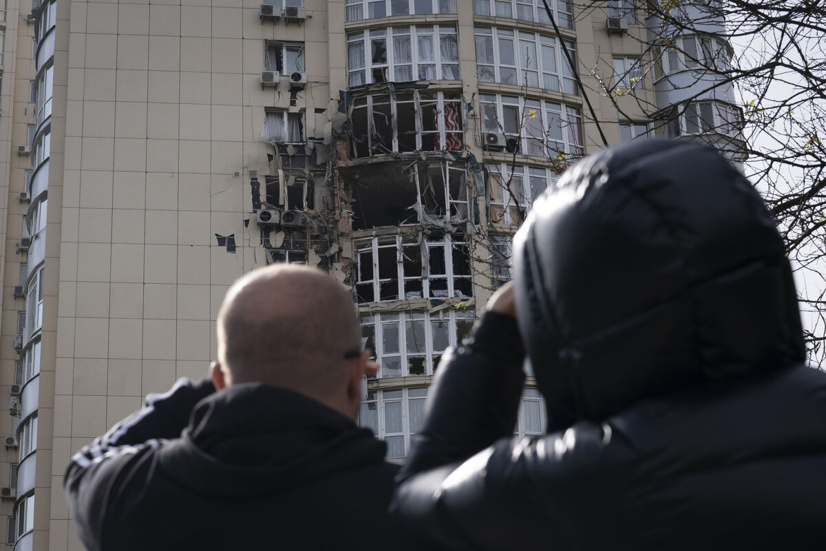 People watch an apartment building damaged by a drone that was shot down during a Russian overnight strike on Kyiv in May 2023. Photo: AP/Andrew Kravchenko People watch an apartment building damaged by a drone that was shot down during a Russian overnight strike on Kyiv in May 2023. Photo: AP/Andrew Kravchenko