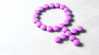 Medicine for woman. Menopause, pms, menstruation or estrogen concept. Female health. Gender symbol made from pink red pills or t