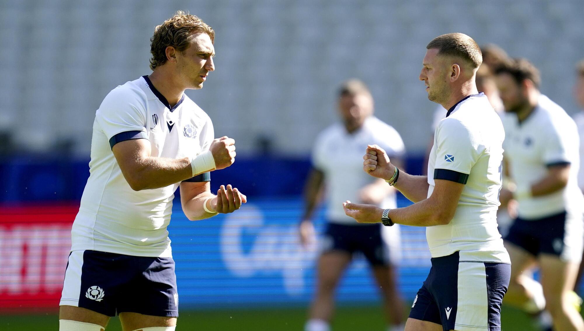 TAKE YOUR CHANCE: Scotland's Jamie Ritchie (left) and Finn Russell play rock paper scissors during the team run at the Stade de France in Saint-Denis. Pic: Andrew Matthews/PA Wire