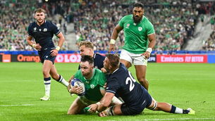 <p>Hugo Keenan of Ireland is tackled by Scotland's Duhan van der Merwe, behind, and Matt Fagerson before scoring his side's fourth try. Picture: Ramsey Cardy/Sportsfile</p>