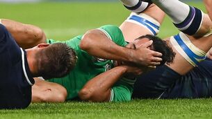 <p>INJURY CONCERN: James Lowe of Ireland reacts after an injury to his eye against Scotland. Pic: Harry Murphy/Sportsfile</p>