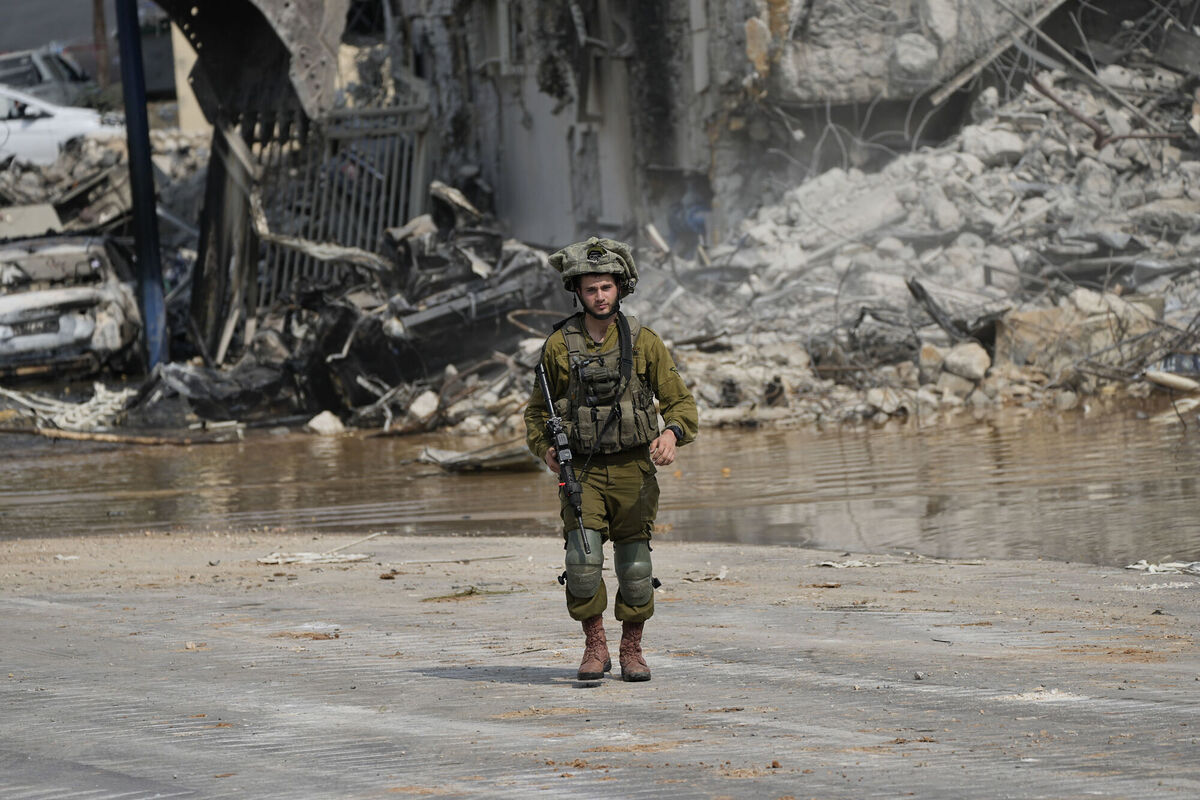 An Israeli soldier walks outside the police station that was overrun by Hamas militants in Sderot, Israel. Picture: Ohad Zwigenberg?AP