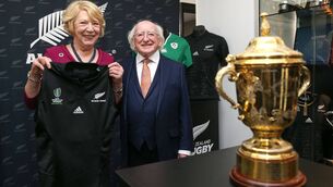 <p>Irish President Michael D. Higgins and wife Sabina pose in front of the Webb Ellis Rugby World Cup after being presented with a Black Ferns shirt during a presentation to New Zealand Rugby in memory of Dave Gallaher, captain of 'The Originals' at New Zealand Rugby House in 2017. Picture: Hagen Hopkins-Pool/Getty Images</p>