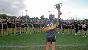 <p>Ciara O'Sullivan, Mourneabbey, shows her team the cup. Pic: Jim Coughlan.</p>