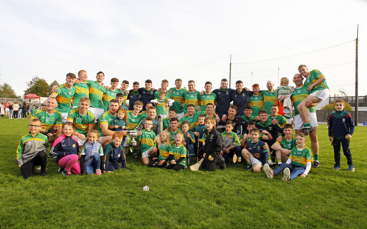 Kilcormac-Kiloughey squad and supporters celebrate with the cup.