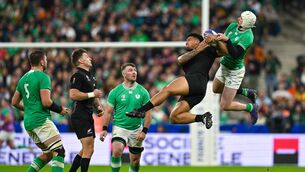 <p>UP FOR IT: Ireland's Mack Hansen and Leicester Fainga'anuku of New Zealand compete for possession at the Stade de France. </p>
