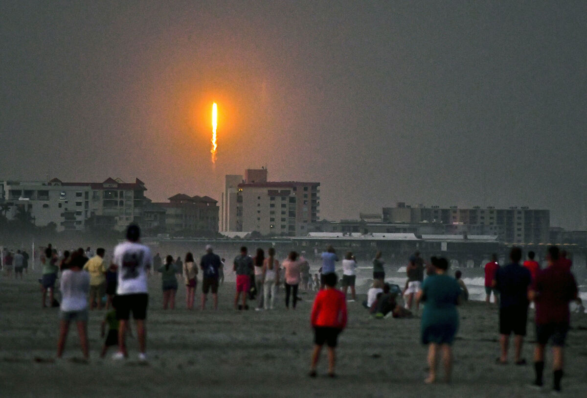 People watch as a SpaceX Falcon 9 lifts off from Launch Complex 40 at Cape Canaveral. Picture: Malcolm Denemark/Florida Today via AP