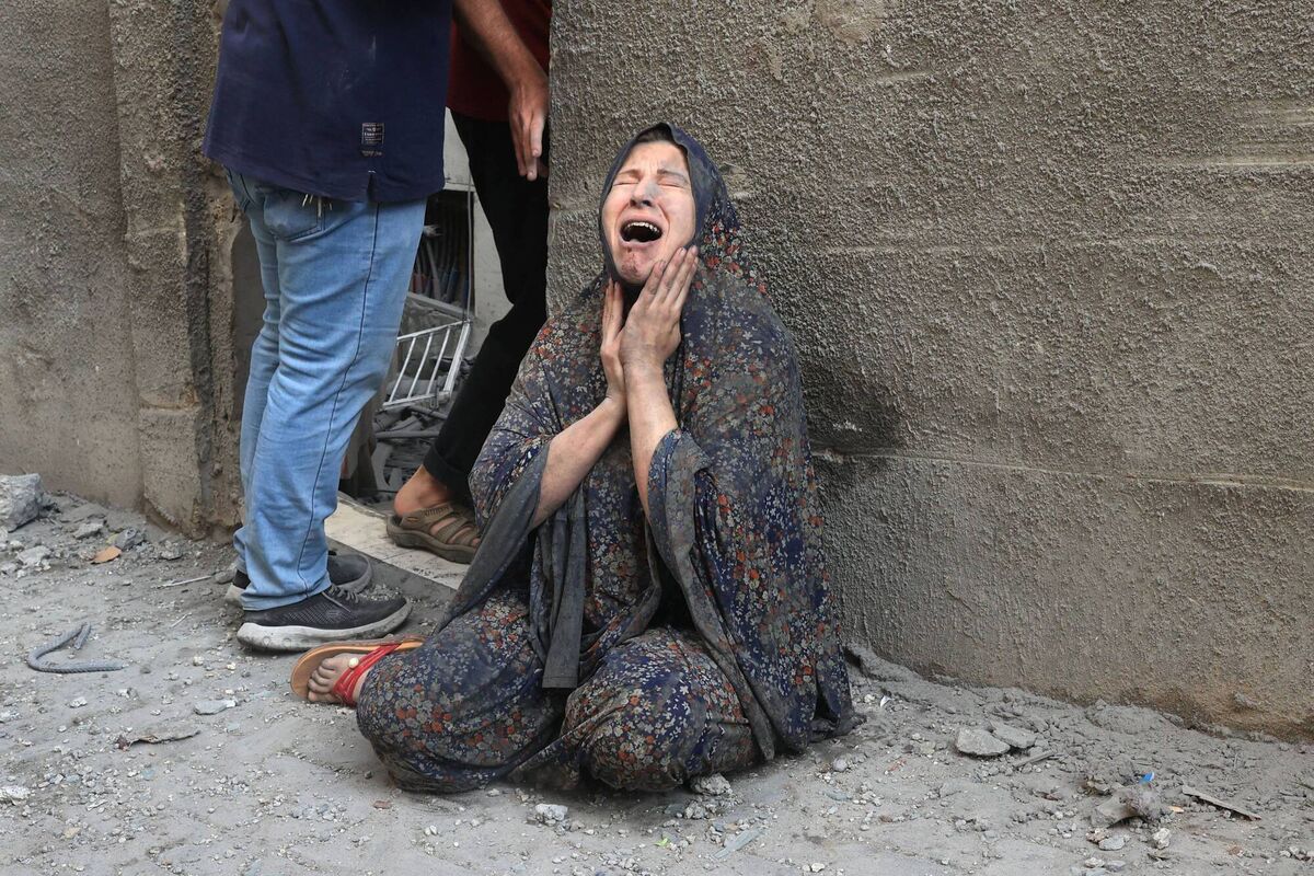A Palestinian woman reacts after an Israeli airstrike on the Rafah refugee camp, in the southern Gaza Strip on October 17, 2023 (Picture:  SAID KHATIB/AFP via Getty Images)