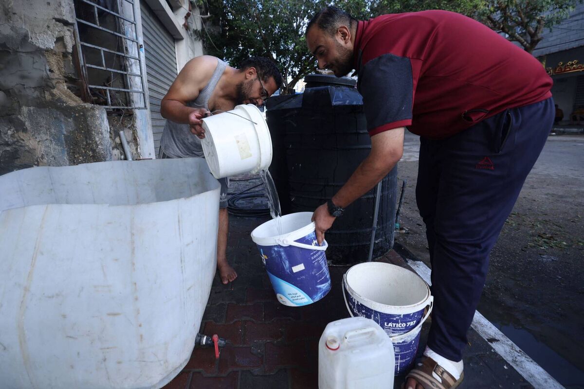 A Palestinian man fills a bucket with water at the Rafah refugee camp, in the southern Gaza Strip on Tuesday. Picture: MOHAMMED ABED/ AFP via Getty Images)