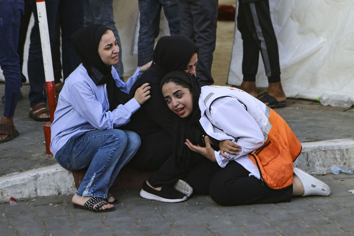 A Palestinian medic, right, cries after learning about the death of a relative at the al-Shifa hospital, following Israeli airstrikes on Gaza City, central Gaza Strip, Tuesday, Oct. 17, 2023. (AP Photo/Abed Khaled)