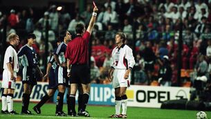 <p>David Beckham of England is sent off by referee Kim Nielsen after lashing out at Diego Simeone of Argentina during the World Cup clash at the Stade Geoffroy Guichard in St Etienne, France. England lost 4-3 on penalties.</p>
