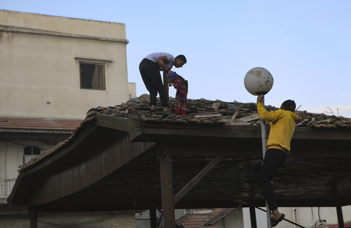 Palestinians inspect the damage at al-Ahli hospital, in Gaza City on Wednesday. The Hamas-run Health Ministry says an Israeli airstrike caused the explosion that killed hundreds at al-Ahli, but the Israeli military says it was a misfired Palestinian rocket. Picture: AP/Abed Khaled