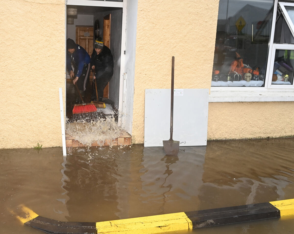 People attempt to clear up flood damage in Rathcormac on Wednesday. Picture: Eddie O'Hare
