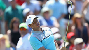 Off-key Rory McIlroy hangs in as Shane Lowry's woes continue