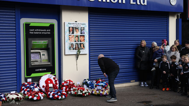 <p>A person lays a wreath on Shankill Road in Belfast during an event ahead of the 30th anniversary of the Shankill bombing (Peter Morrison/PA)</p>