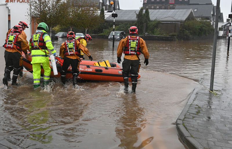 Emergency personnel working in the floods in Main street Midleton. Picture: Eddie O'Hare Emergency personnel working in the floods in Main street Midleton. Picture: Eddie O'Hare