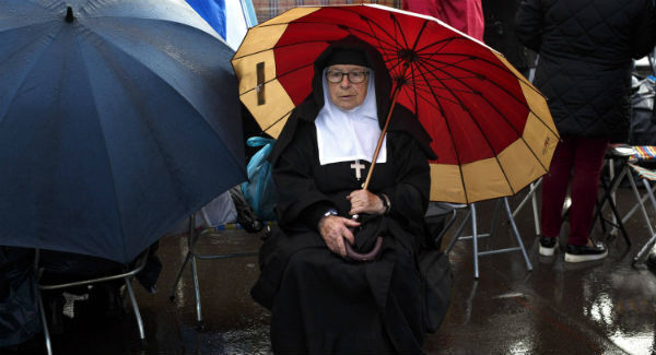 A nun waits in the rain for the arrival of Pope Francis in the Sanctuary of Fatima yesterday. Picture: Pablo Blazquez Dominguez/Getty A nun waits in the rain for the arrival of Pope Francis in the Sanctuary of Fatima yesterday. Picture: Pablo Blazquez Dominguez/Getty