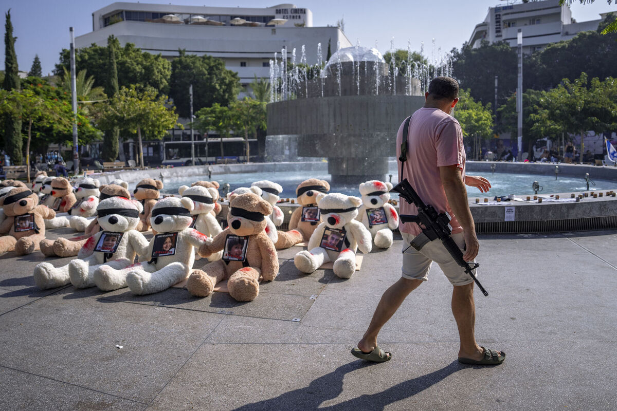 An off-duty Israeli soldier walks by an installation of blindfolded giant teddy bears adorned with photos of Israelis held captive in Gaza, in Tel Aviv, Israel. The installation is meant to draw attention to over 200 people who were abducted by Hamas militants during a bloody and unprecedented Oct. 7 cross-border attack. An off-duty Israeli soldier walks by an installation of blindfolded giant teddy bears adorned with photos of Israelis held captive in Gaza, in Tel Aviv, Israel. The installation is meant to draw attention to over 200 people who were abducted by Hamas militants during a bloody and unprecedented Oct. 7 cross-border attack.