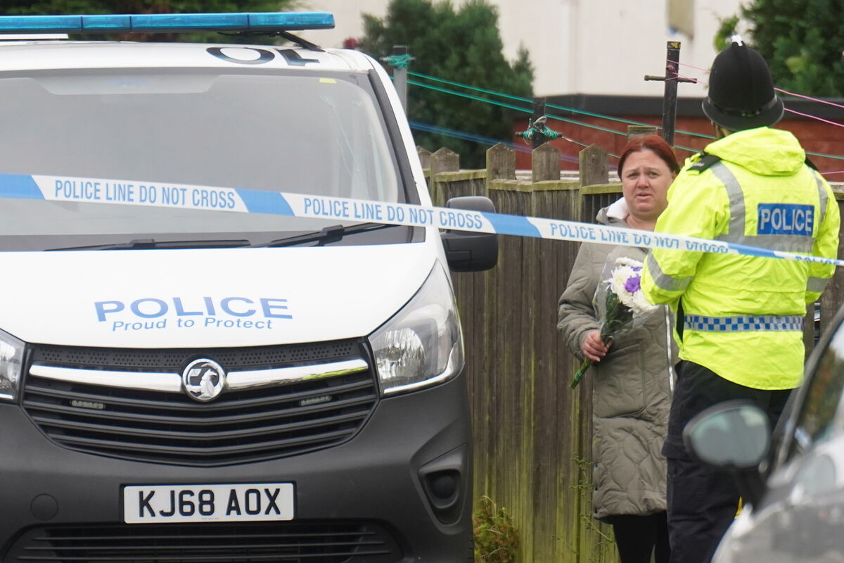 A woman arrives with floral tributes after a 54-year-old man died after he was savaged by what police believe was an XL bully on Maple Terrace in Shiney Row near Sunderland on Tuesday evening. Picture: Owen Humphreys/PA Wire