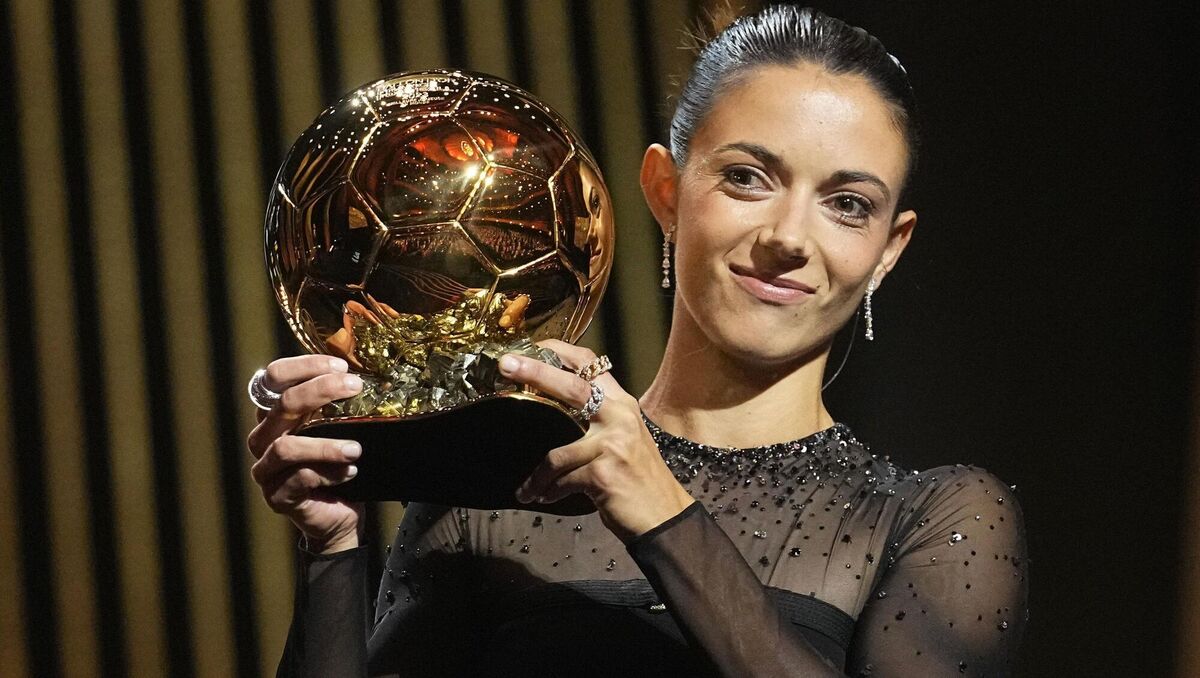 Bonmati holds the trophy.