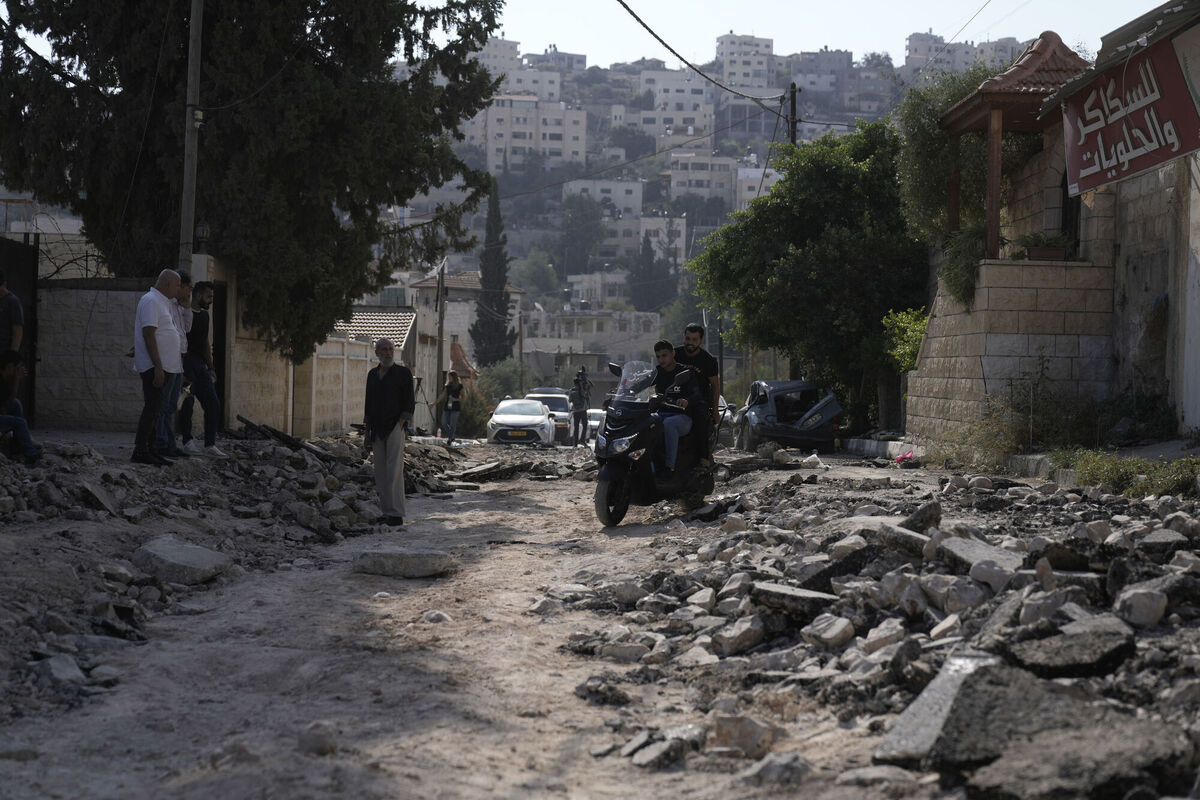 Palestinians ride a scooter through a street destroyed in an Israeli military raid on Jenin, West Bank, Wednesday, Nov. 1, 2023. Picture: AP Photo/Majdi Mohammed