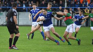 <p>DOUBLE TROUBLE: Kerins O'Rahilly's Tom Hoare breaks away from Mid Kerry's Gavin Horan. Photo: Don MacMonagle</p>