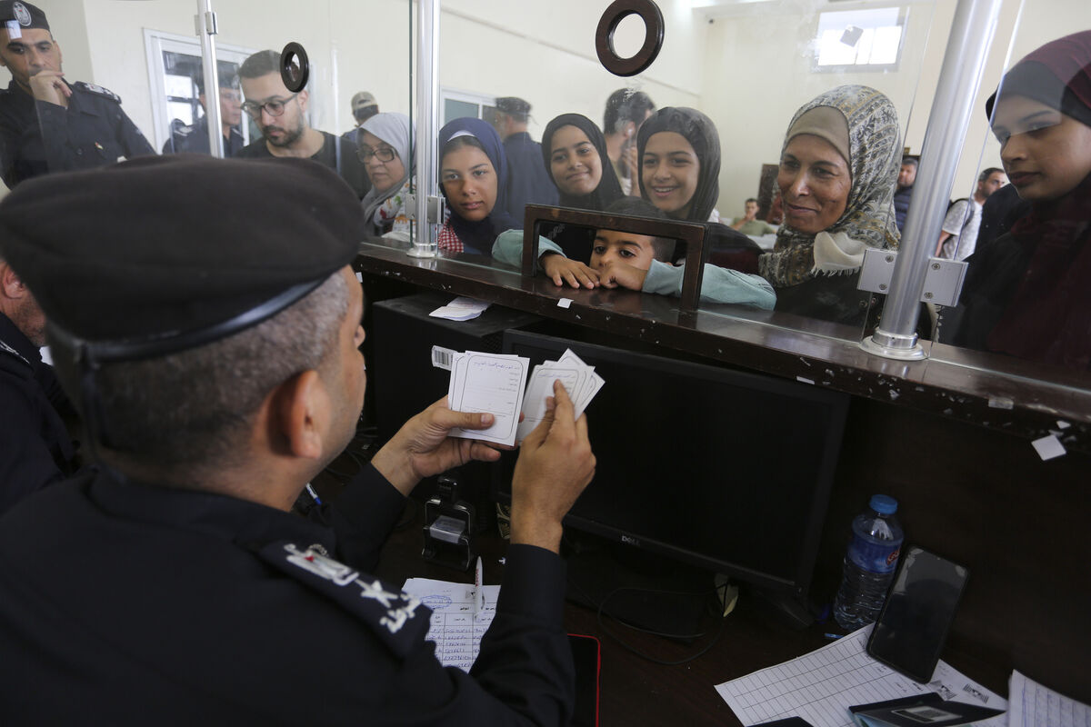 Palestinians with dual nationality register to cross to Egypt on the Gaza Strip side of the border crossing in Rafah on Thursday. Picture: AP/Hatem Ali