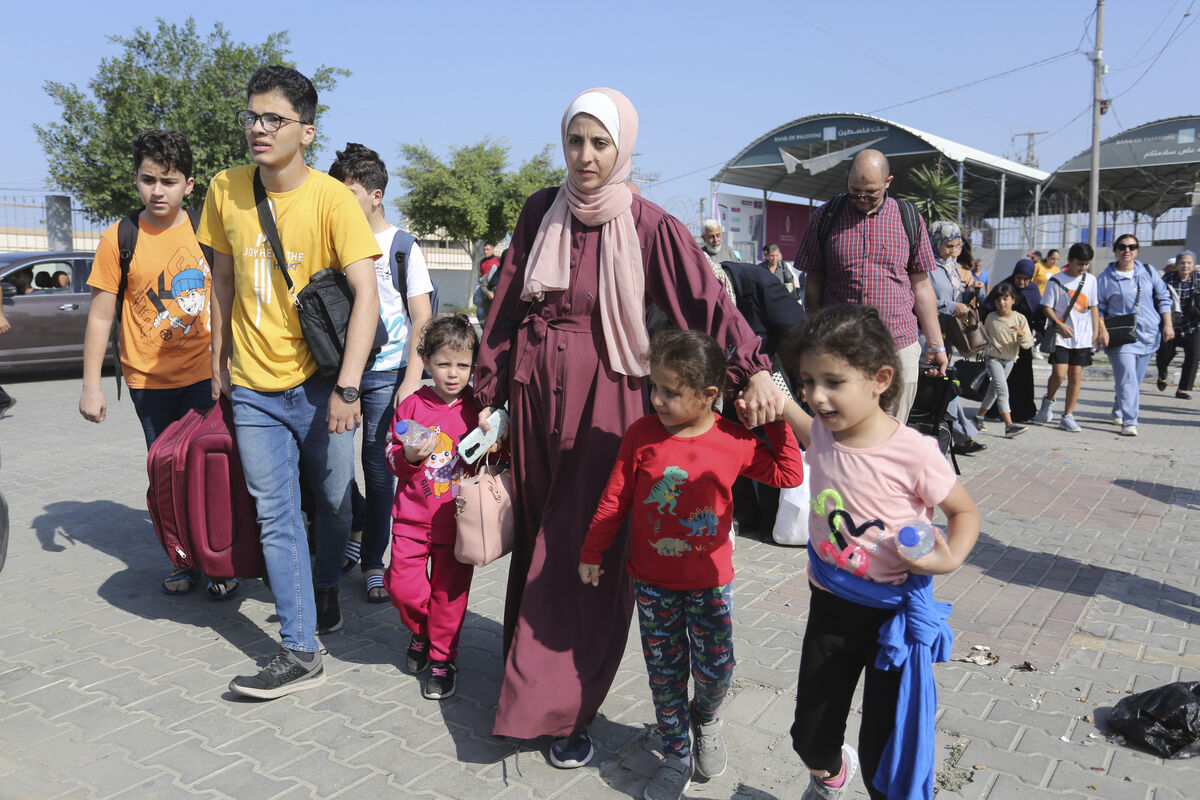 Palestinians cross to the Egyptian side of the border crossing with the Gaza Strip in Rafah on Wednesday. Picture: AP/Hatem Ali