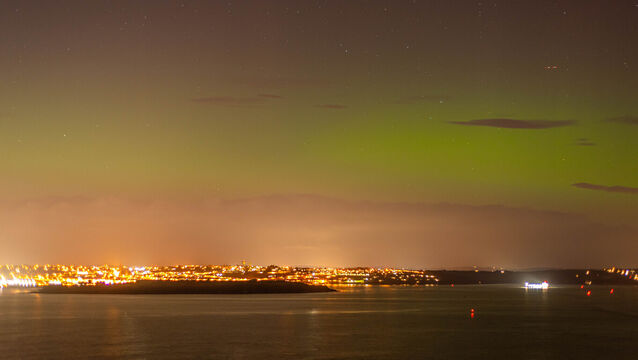 <p>The distinctive green and red hues of the aurora borealis shine bright in the skies over Cobh and Cork Harbour in this shot captured from Camden Fort Meagher, Crosshaven. Picture: Cian O'Regan.</p>