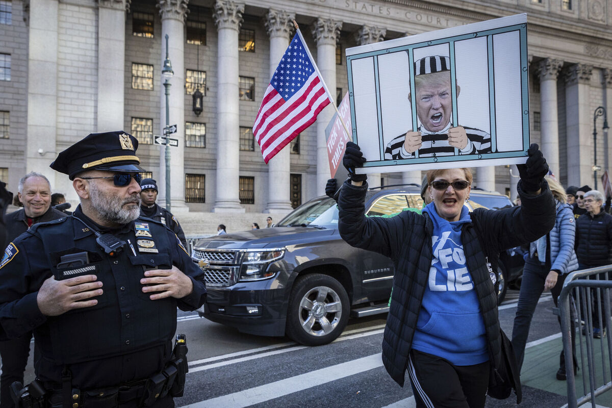 People protest against former President Donald Trump outside the New York Supreme Court, Monday, Nov. 6, 2023, in New York. (AP Photo/Stefan Jeremiah)