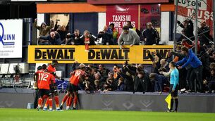 <p>Luton Town's Tahith Chong (hidden) celebrates scoring their side's first goal of the game with team-mates and fans.</p>