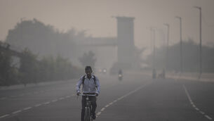 Masks have returned to the streets of New Delhi as residents grapple with the annual surge in air pollution in the Indian capital (Altaf Qadri/AP)