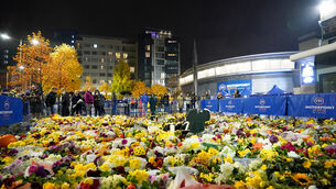 <p>Fans look at floral tributes outside the Motorpoint Arena, Nottingham, ahead of a memorial for Nottingham Panthers’ ice hockey player Adam Johnson (Zac Goodwin/PA)</p>