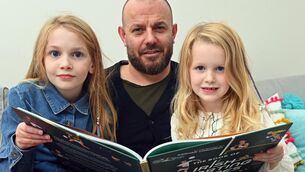 <p>Author Adrian Russell with his daughters Robin and Ruby in Cork. Pic: Denis Minihane.</p>