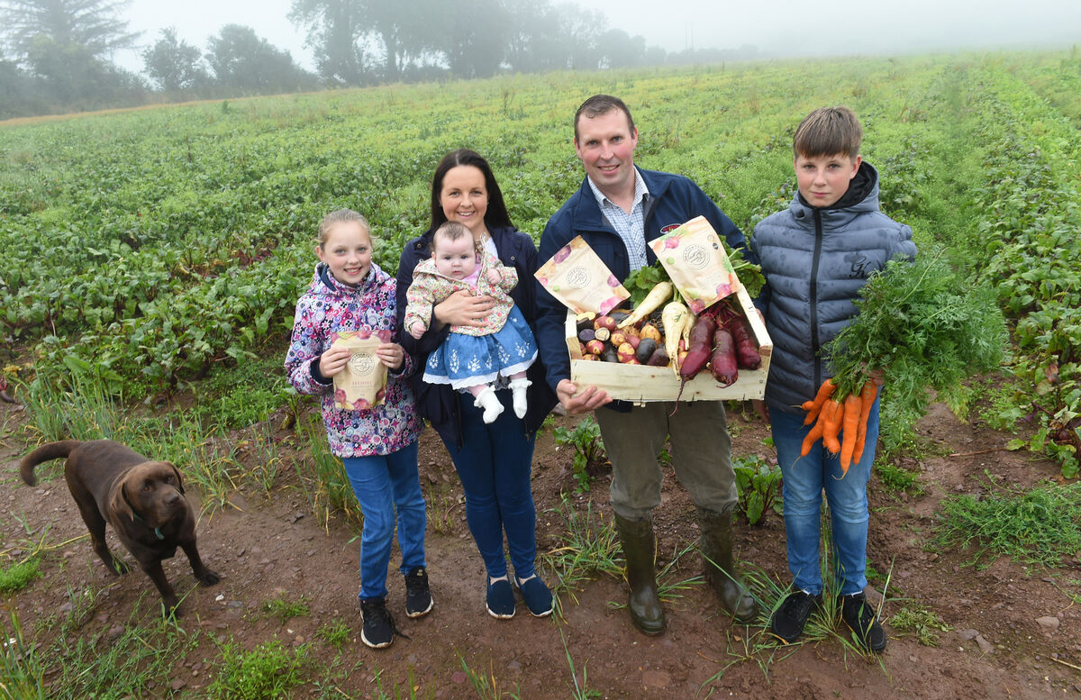 The Burns family of Joe's Farm Crisps with a previous crop and beetroot growing in the fields at Killeagh, Co Cork. Picture: Larry Cummins