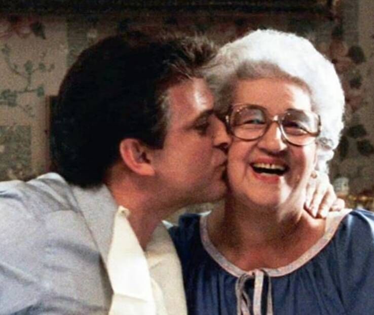 Joe Pesci planting a kiss on Martin Scorsese's mother during Goodfellas.