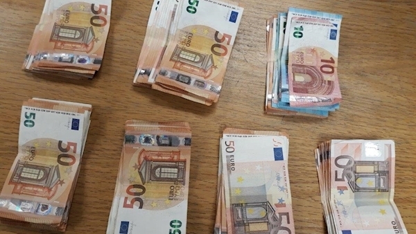 Cannabis labelled as 'clothing' and cash seized in two separate raids