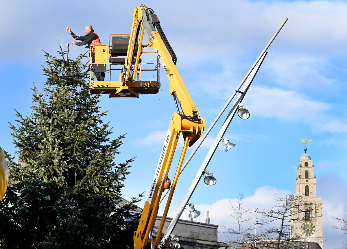 The star being put on the Christmas tree at The Coal Quay on Cornmarket Street. Picture: Eddie O'Hare
