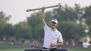 Nicolai Hojgaard of Denmark poses with his trophy after winning the DP World Tour Championship in Dubai (Kamran Jebreili/AP)