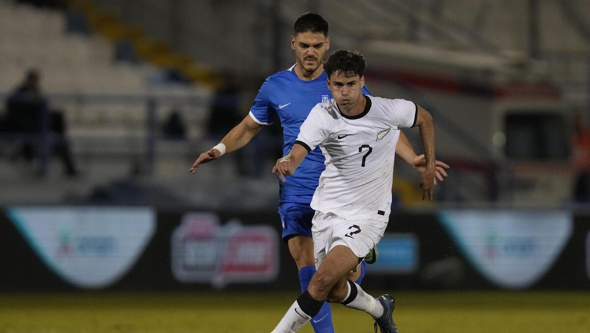 New Zealand's Matt Garbett beats Greece's Konstantinos Mavropanos during an international friendly.